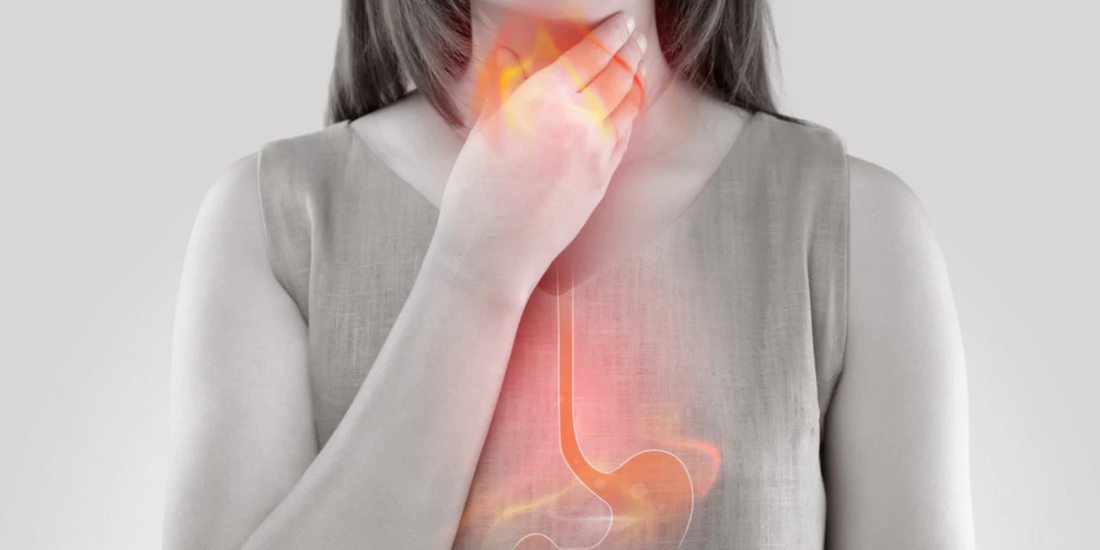 Person clutching throat with highlighted esophagus and stomach showing a burning sensation