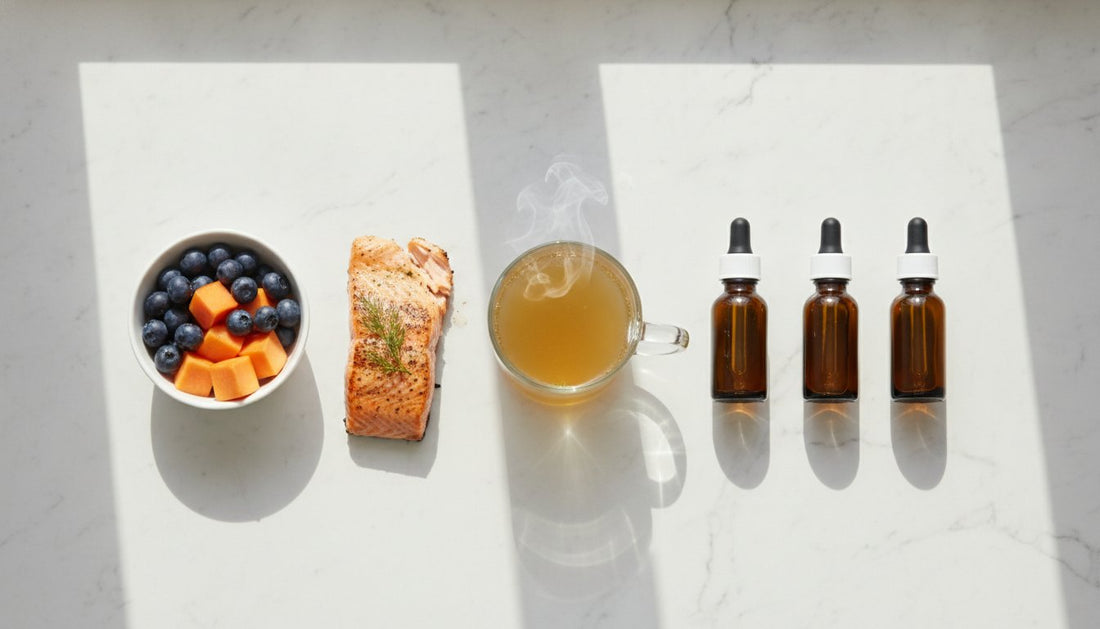 Salmon, blueberries, papaya, steaming broth, and dropper bottles arranged on a sunlit marble surface