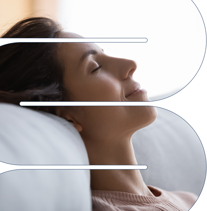 Woman reclining on a pillow with eyes closed, relaxed profile against a bright background with rounded navy graphic overlays