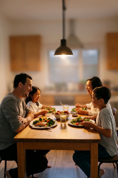 Family of four enjoying a healthy dinner together at a wooden table in a warmly lit kitchen