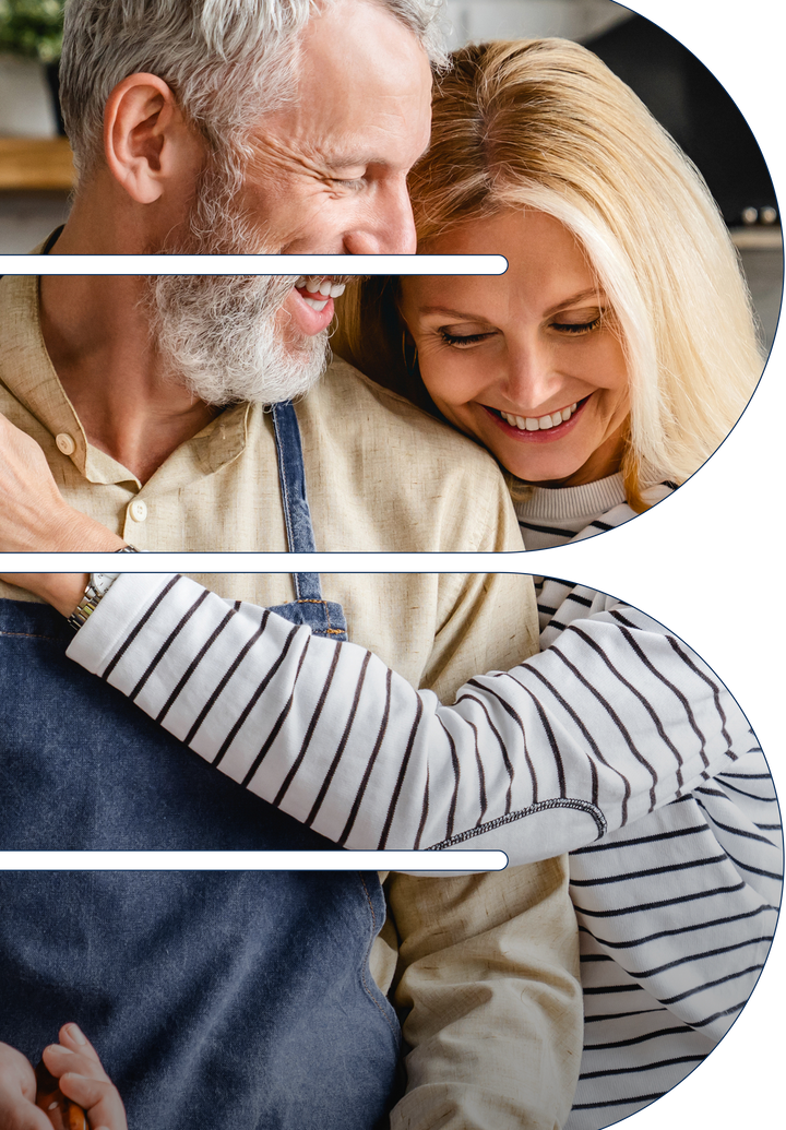 Smiling couple embracing with the woman resting her head on the man's shoulder in a warm kitchen setting