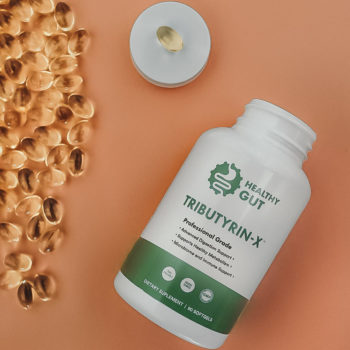Photo of Tributyrin-X on a tan background, gel capsules on left side
